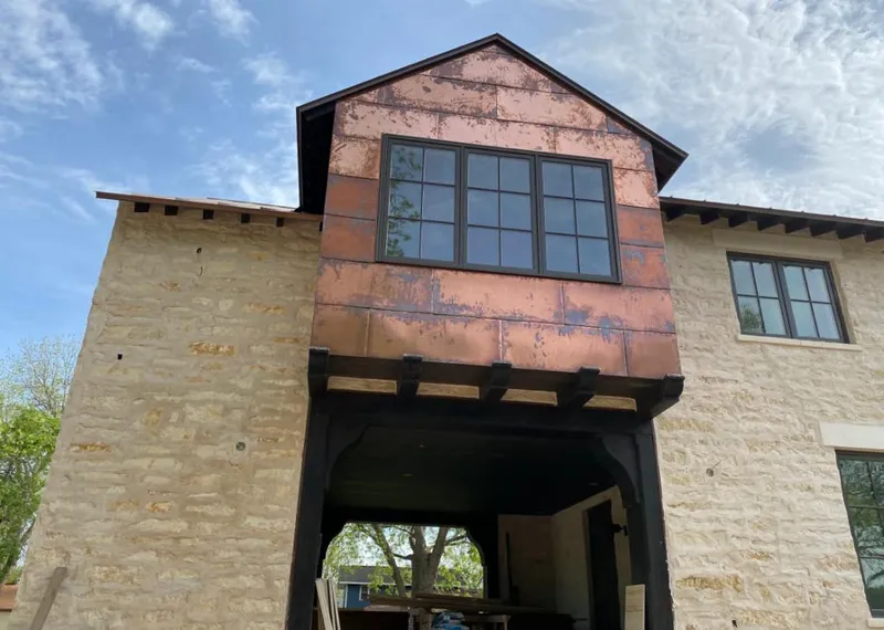 Copper metal panel facade on a stone building for Roof Repair in Mesquite