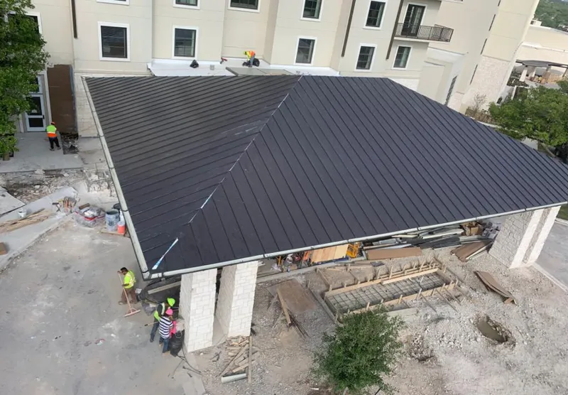 Metal roofing installation team working on a commercial building in Mesquite